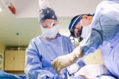 Scarlett Isaak, Operating Room Nurse / Practitioner, and Gary Parker, Chief Medical Officer / Maxillofacial Surgeon, performing a surgery.