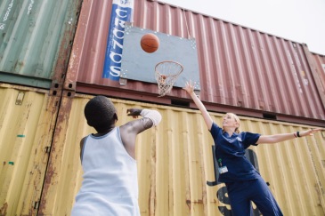 Paul Bernard, plastics patient, playing basketball with his Hand Therapist, Chelsea Darlow.