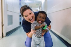 Rachel Lappin, Screeing Nurse, with one of the cleft lip and palate patients in the ward hallway.